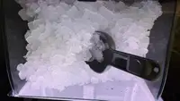 Close up photo of ice with scooper.