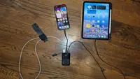 INIU Pocket Rocket 50 connected to an iPad, iPhone, and Apple Watch against a wooden surface.
