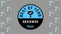 Reviewed's Best of Year Award badge on a gray background with pans and stand mixers
