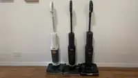 Roborock F25 Series Wet-Dry Vacuums stand against a wall in a residential hallway