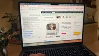 A laptop screen showing Alexa for Shopping on Amazon.com answering a question about whether a self-cleaning litter box can handle multiple cats safely.
