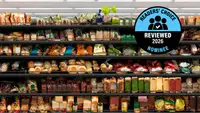Rows of packaged bread and baked goods on grocery store shelves, with a 