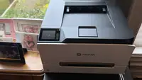 A Xerox color printer next to photo frames
