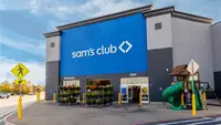 Photo of a Sam's Club storefront with flowers and a playground set
