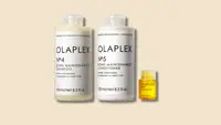 The Olaplex Wash & Shine Hair Kit, including No. 7 Bonding Oil, No. 4 Bond Maintenance Shampoo, and No. 5 Bond Maintenance Conditioner on a beige background.