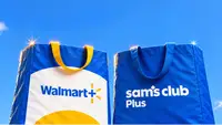 Walmart+ and Sam’s Club Plus branded tote bags held up against a blue sky