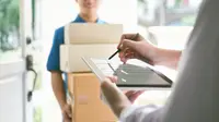 Woman signing for a package