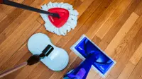 Three of the best mops we tested sit on a shiny hardwood floor