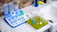 The best bottle drying racks, Boon Grass and Dr. Brown's Universal Drying Rack, holding bottles