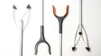 Four different reacher grabber tools on a white background