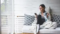 woman relaxing on a couch with a cup of tea