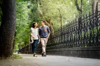 man and woman walk on pavement