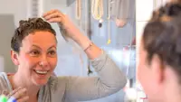 A photo of a woman dyeing her hair.