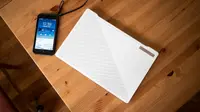 An overview shot of the Zephyrus G14 showcasing its matte white lid and AniMe LED display