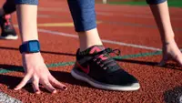 A woman wearing Nike running shoes on a track