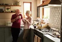 A senior couple in their kitchen at home