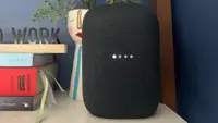 Google's Nest Audio smart speaker sits on a shelf.