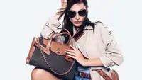 Woman holding Michael Kors bag