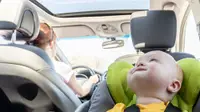 Boy in car seat riding in car