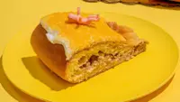 Slice of king cake on a yellow plate
