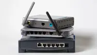 A number of wireless routers, stacked on top of one another.