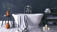 A rustic and dark bathroom with a white standalone tub.