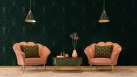 An Art Deco inspired sitting room with two pink armchairs and green accent table.