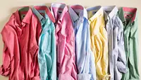 Pile of wrinkled dress shirts in a rainbow of colors