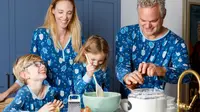 A family wearing matching Hanukkah pajamas making potato pancakes in a kitchen