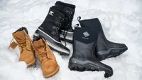 A collection of winter boots in the snow