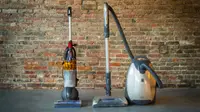 A bagged canister vacuum next to a bagless upright