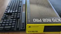 A keyboard next to its packaging box
