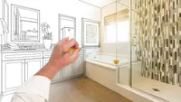 Person using pencil to draw sketch of bathroom renovation.