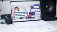 An open and powered on laptop sitting on a desk