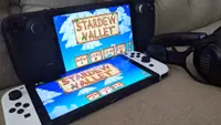 Two handheld gaming consoles next to a wireless headset