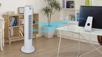 A tower fan providing ventilation in a home office space.