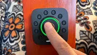 A person using the fingerprint scanner on the Ultraloq U Bolt Wi-Fi Pro smart lock