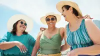 Three people in sun hats and sunglasses laughing