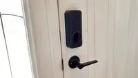 Close up of a door with a smart lock equipped.