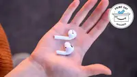 White bluetooth headphones in hand
