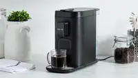Product shot of the Instant Dual Pod Plus Coffee Maker on granite countertop in kitchen.