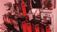 A large collection of Star Wars toys from Hasbro and Funko, most of them in black-and-red Black Series packaging.