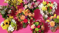 A variety of flowers against a pink background.
