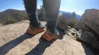 A hiker wearing a pair of Hoka running shoes