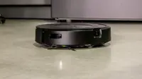 The iRobot j7+ Combo robot vacuum cleans a kitchen floor.