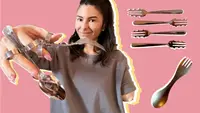One-armed person smiling while holding up assorted cutlery perfect for one-handed use that makes eating easier.