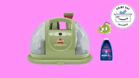 The Bissell Little Green Portable Carpet Cleaner against a pink background
