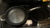 The Anolon X frying pan on an electric cooktop