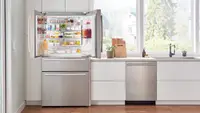 Bosch B36CL80SNS stainless steel fridge open in a kitchen.