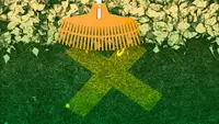A rake pulls away leaves to expose an X.